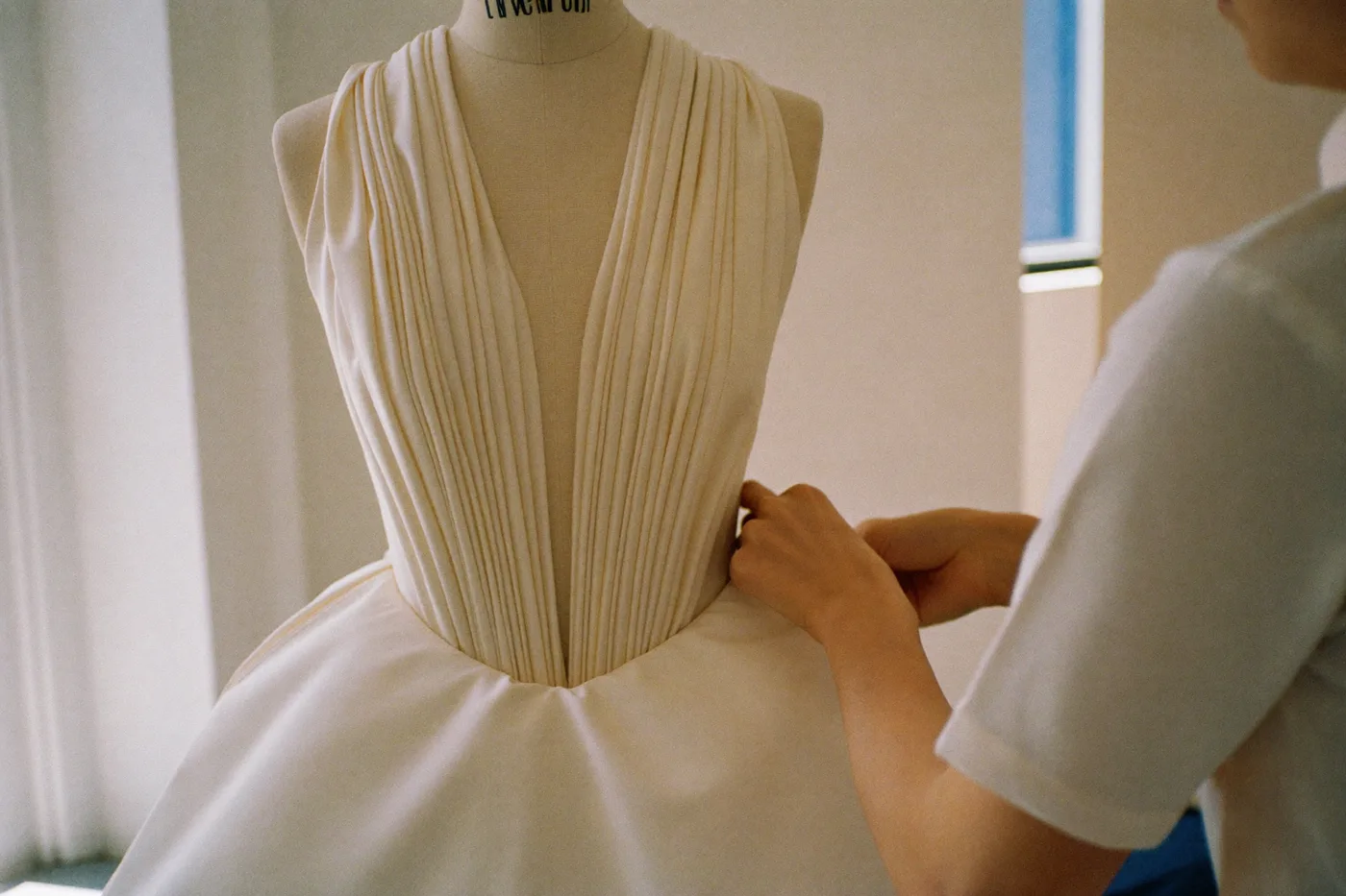 Luxus Brautkleid auf einer Schneiderpuppe im Atelier während der Anpassung des Saums