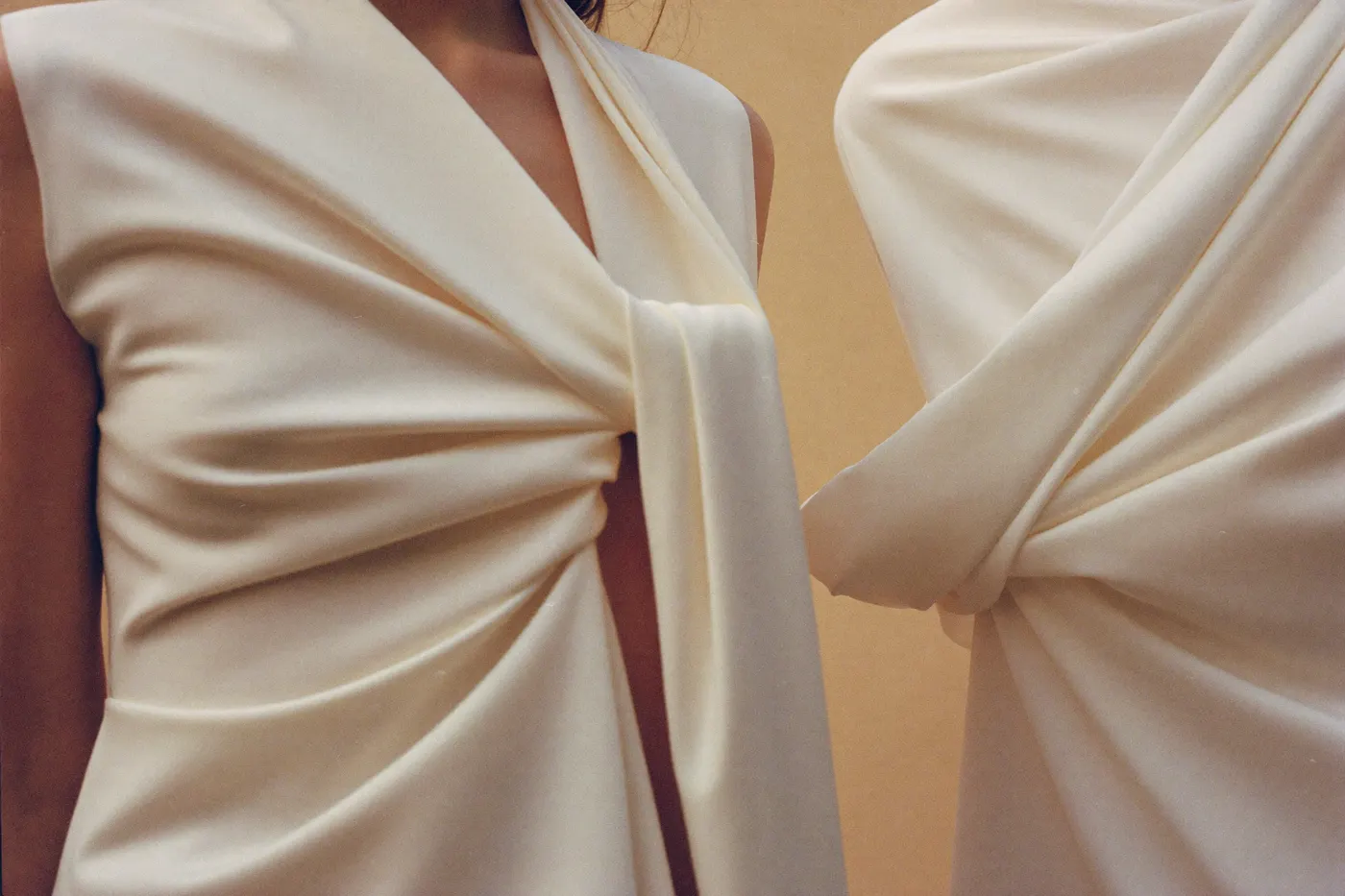 Stoffdetail eines minimalistischen Brautkleids: glatter Crêpe und strukturierter Mikado in Ivory